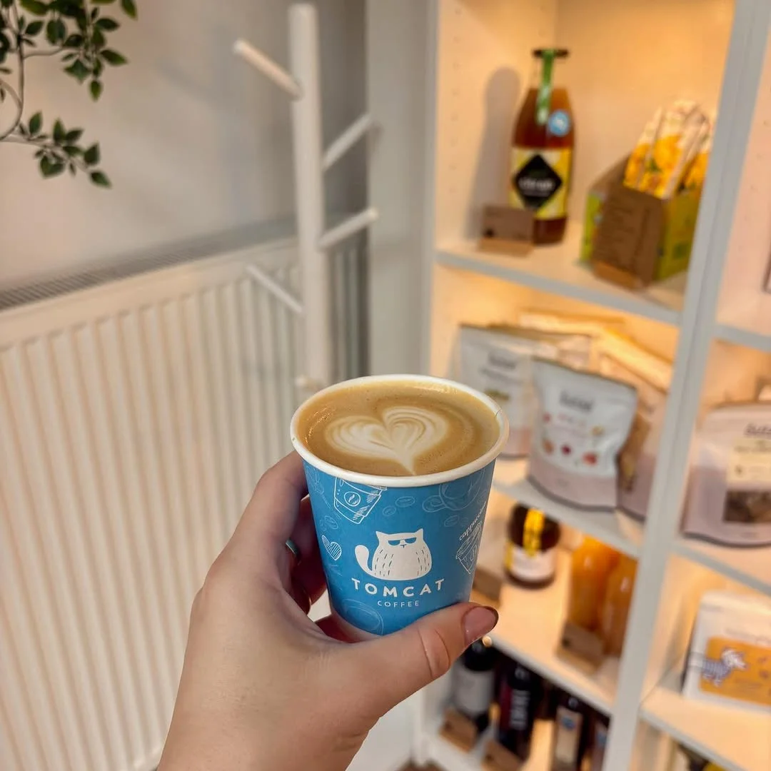 Latte art in Tomcat Coffee branded cup